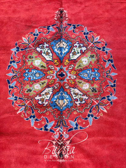 Deep Red Rug with Geometric and Floral Designs