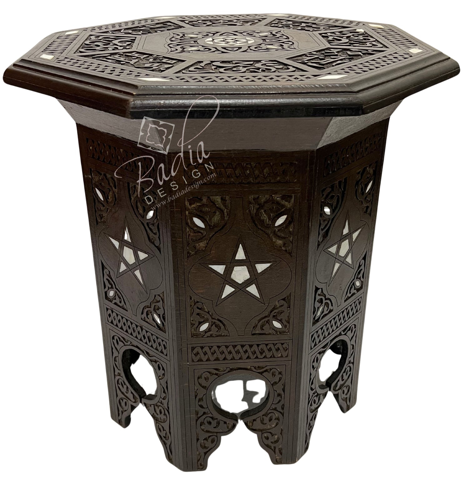 Decorative hexagonal side table with intricate patterns on a white background