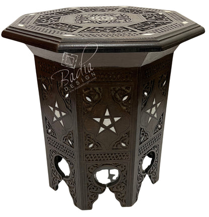 Decorative hexagonal side table with intricate patterns on a white background
