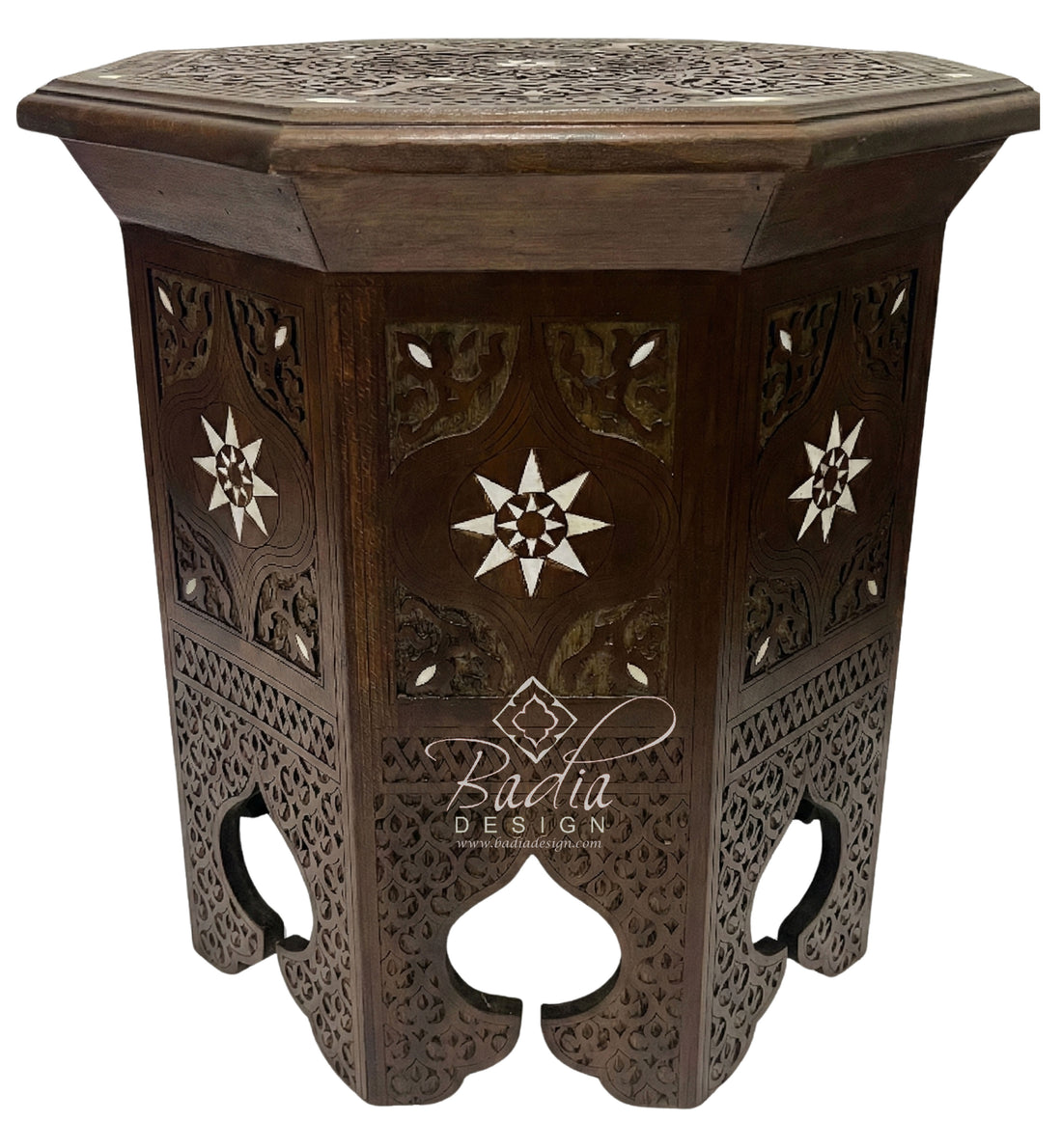 Decorative wooden side table with intricate carvings on a white background