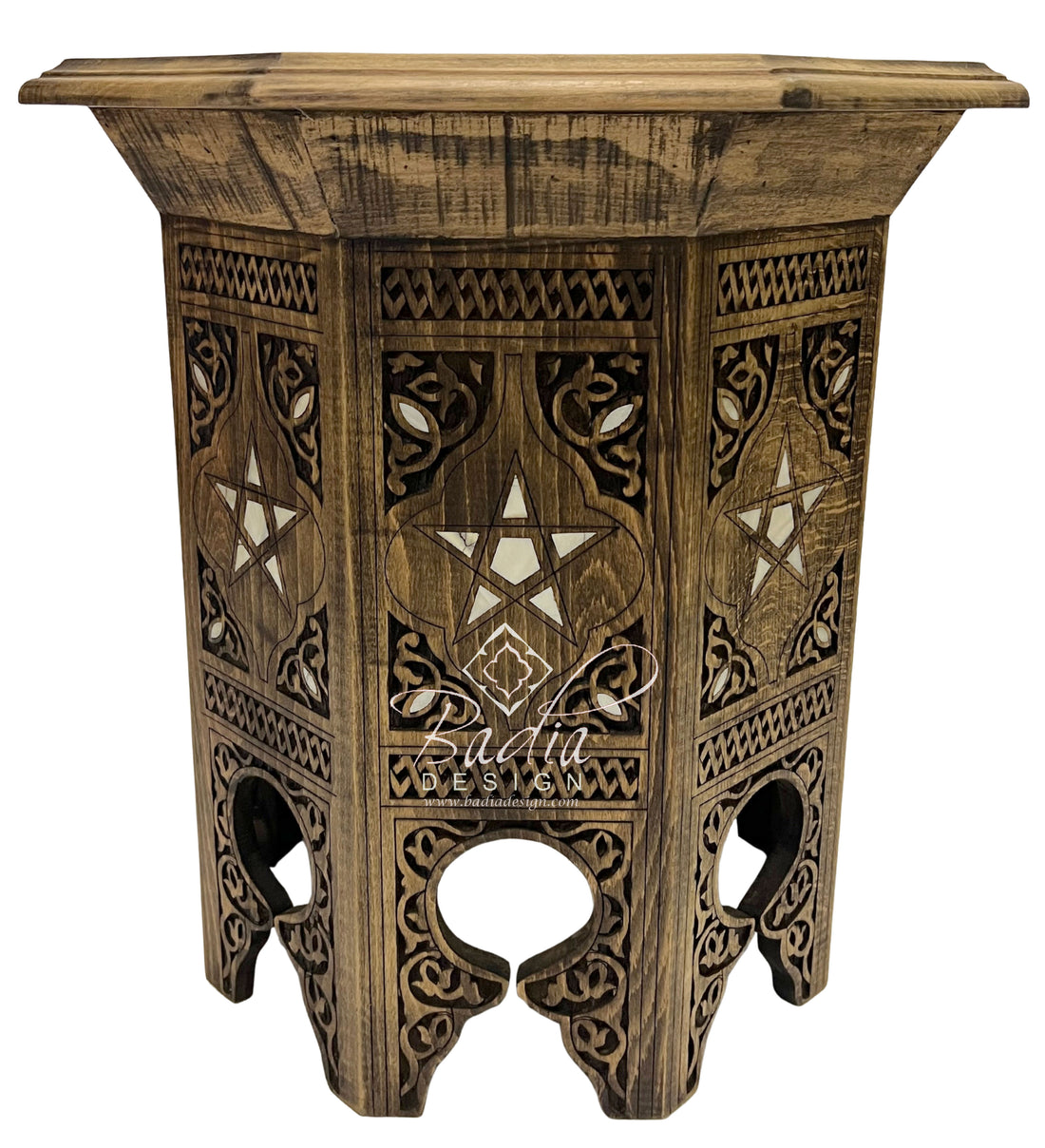 Wooden side table with intricate carvings on a white background