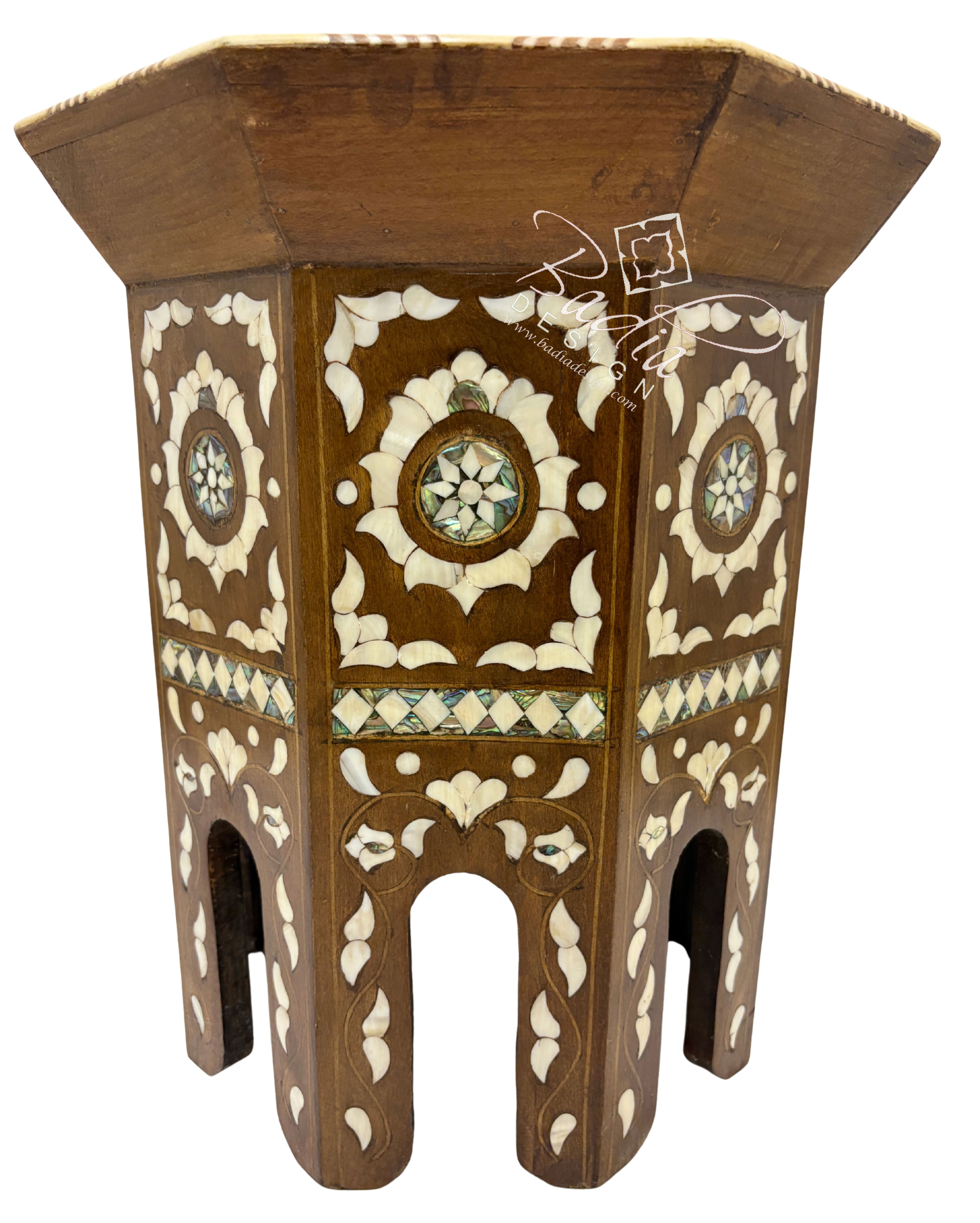 Decorative wooden stool with intricate carvings on a white background
