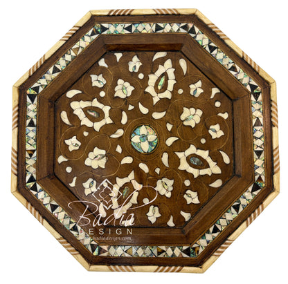 Decorative wooden panel with intricate inlay design on a white background