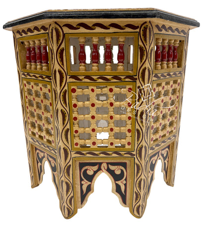 Decorative wooden side table with intricate patterns and designs on a white background