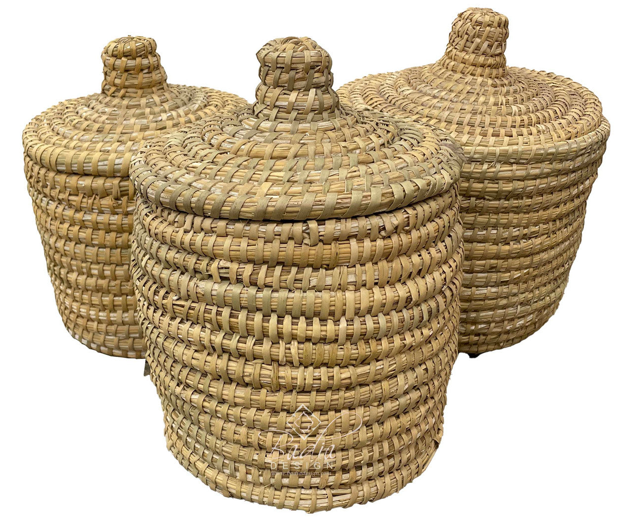 Three woven baskets with lids on a white background