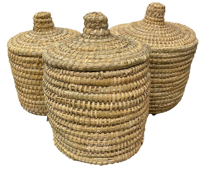 Three woven baskets with lids on a white background