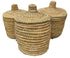 Three woven baskets with lids on a white background