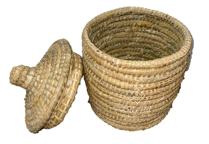 Woven basket with a lid on a white background