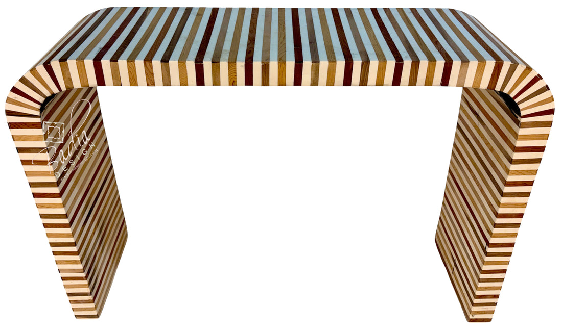 A modern console table with a curved top and legs, featuring a striped inlay pattern of light and dark wood tones, set against a plain white background.