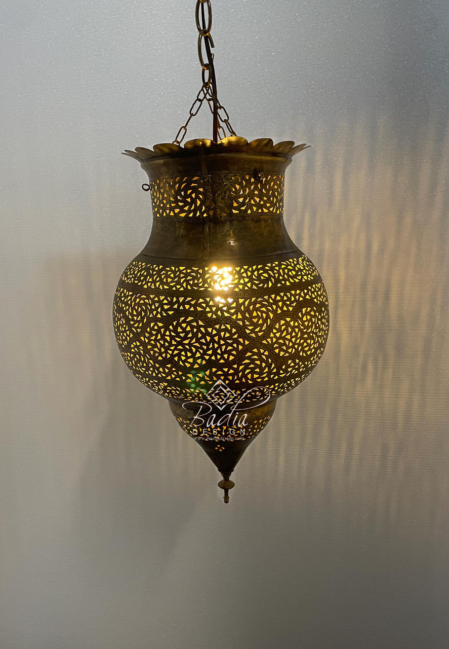 Decorative hanging lamp with intricate patterns on a plain background