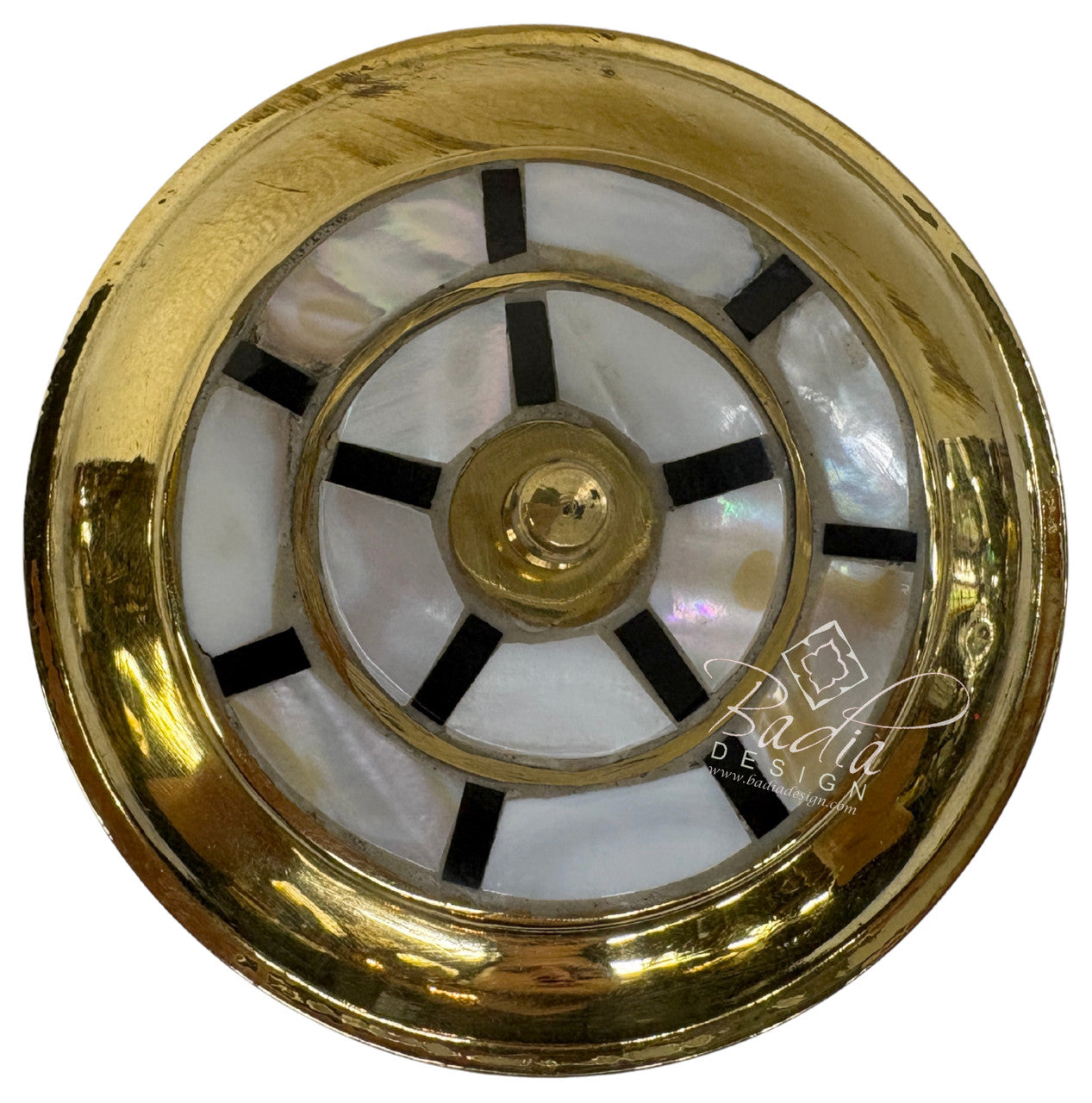 Decorative clock face with gold and black design on a white background