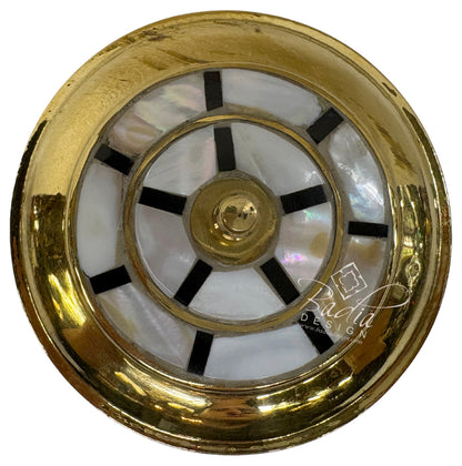 Decorative clock face with gold and black design on a white background