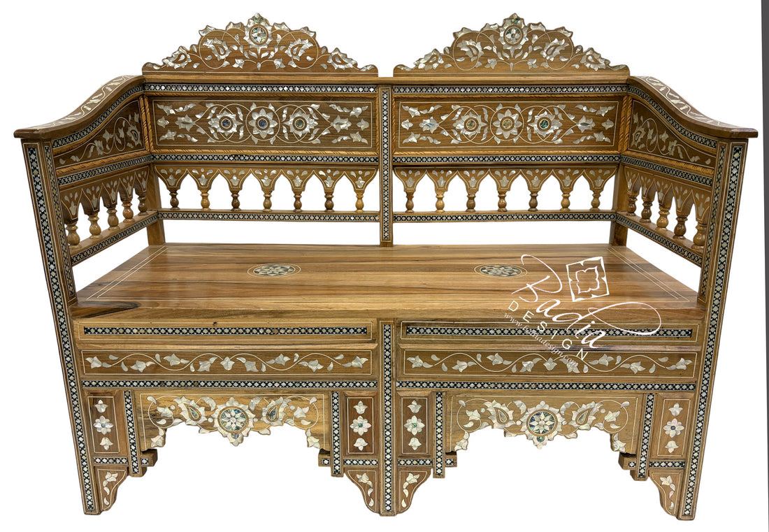 Decorative wooden bench with intricate carvings on a white background