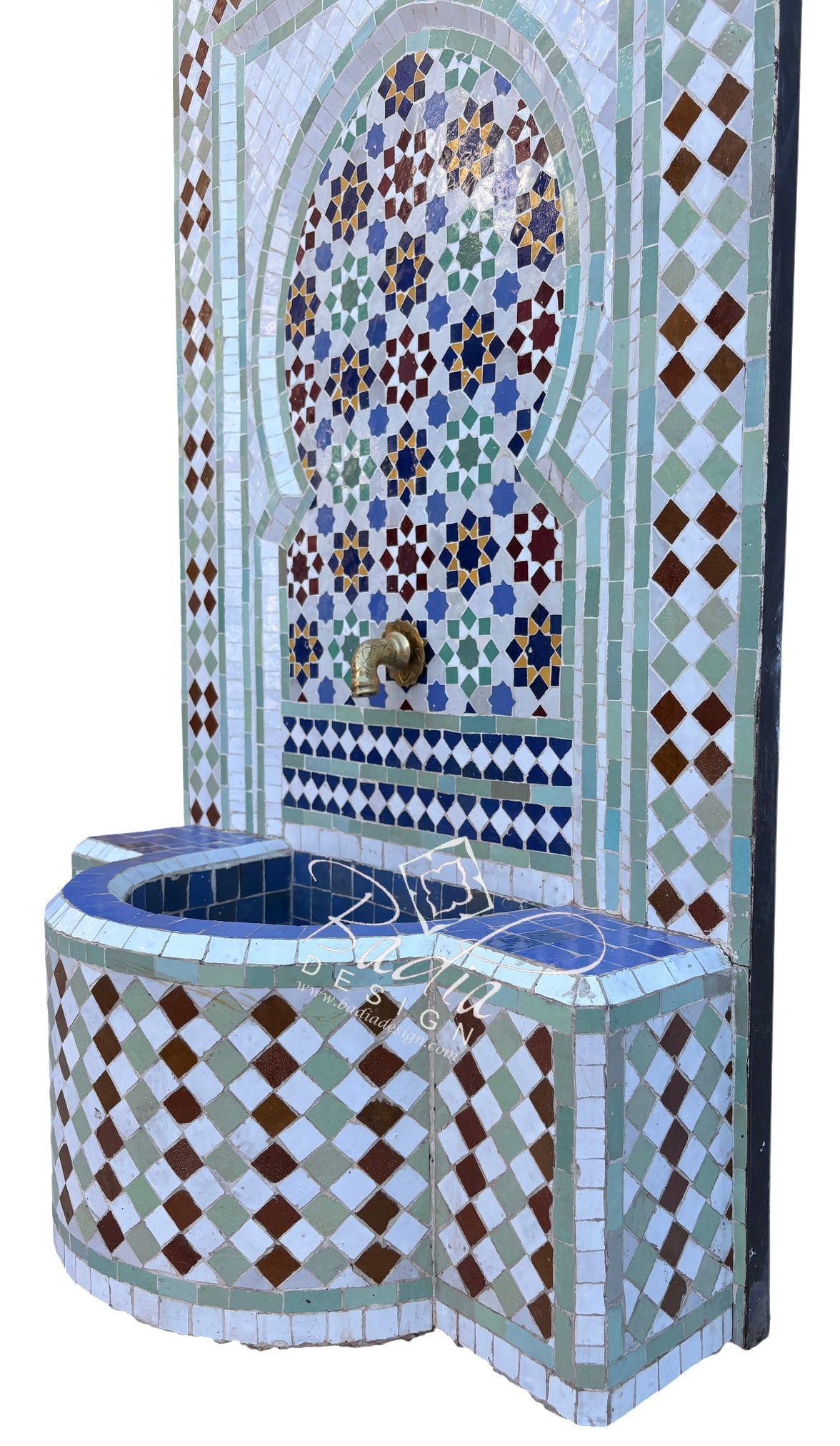 A Moroccan-style mosaic fountain wall and basin set with blue, white, green, and brown tile patterns, featuring a brass faucet and a curved tiled basin against a white background.