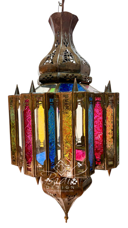 An ornate brass hanging lantern with colorful stained glass panels in pink, blue, yellow, and green, isolated on a white background.
