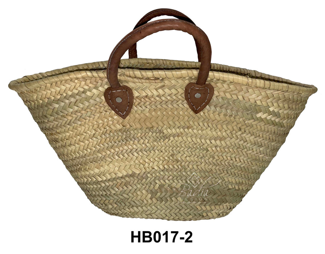 Woven basket with brown handles on a white background