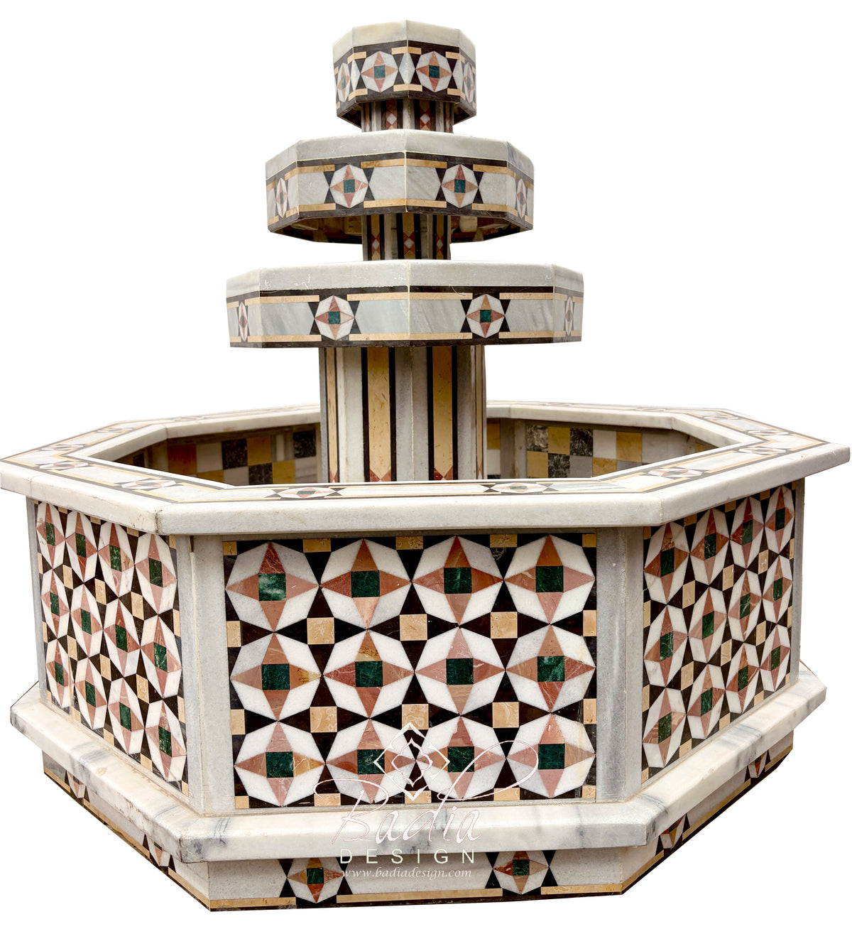 An ornate multi-tiered stone fountain with geometric mosaic inlay patterns in beige, brown, green, and white, isolated on a white background.