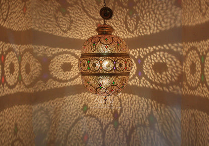 Decorative hanging lamp casting shadows on a patterned wall