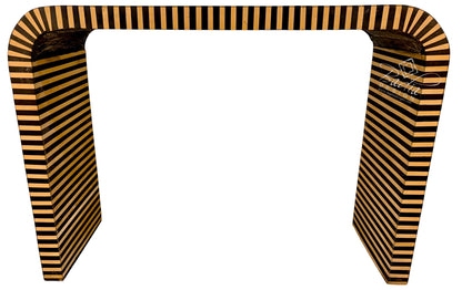 A modern U-shaped console table with a bold black and warm tan striped pattern, shown against a plain white background.