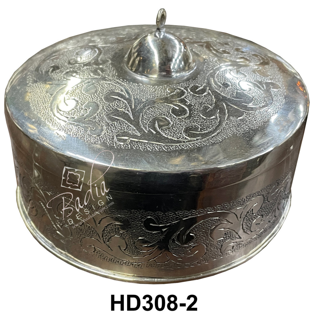 Decorative silver container with intricate designs on a white background