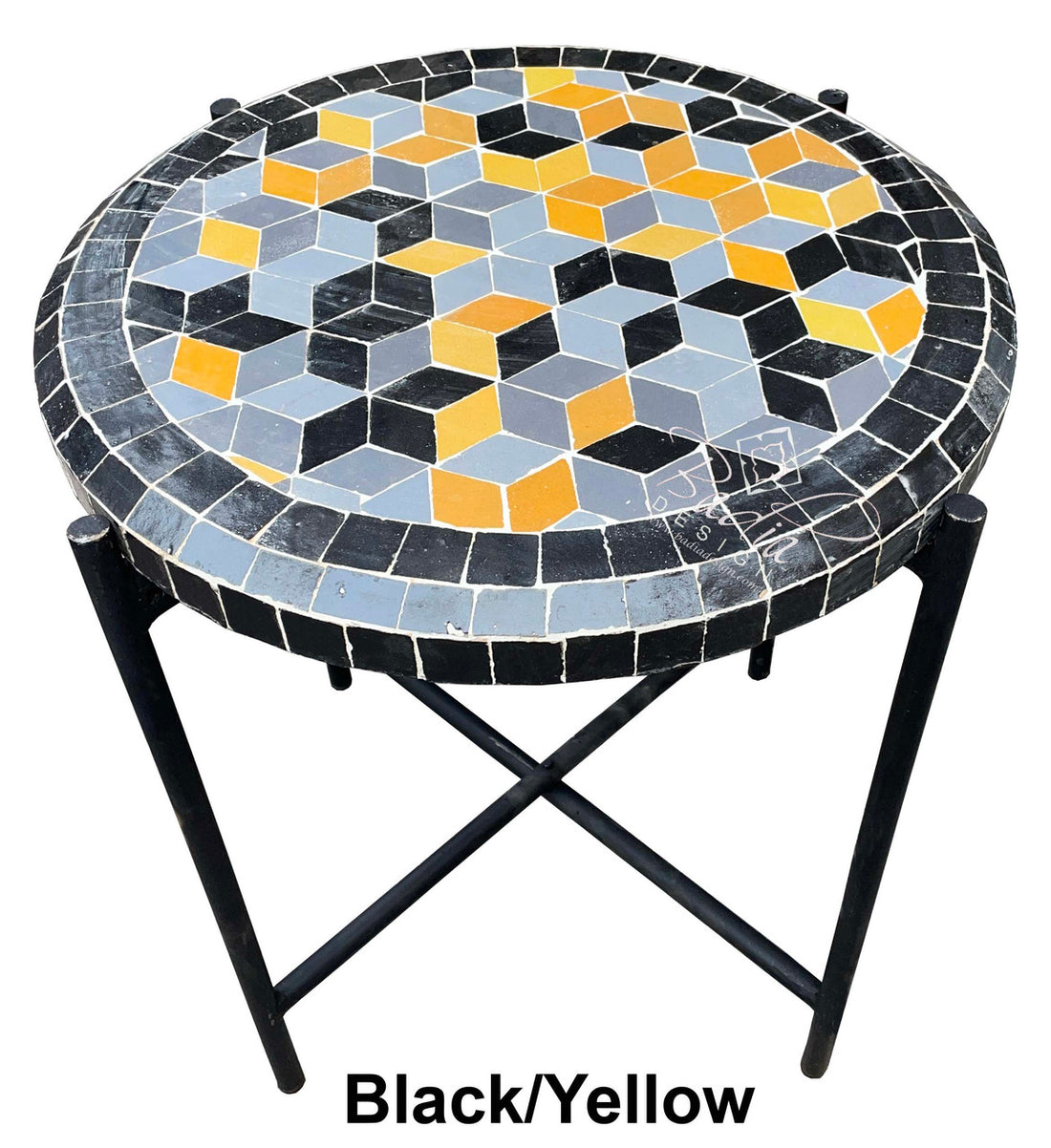 Round mosaic table with black, yellow, and blue geometric pattern on a white background