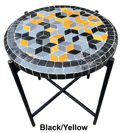Round mosaic table with black, yellow, and blue geometric pattern on a white background