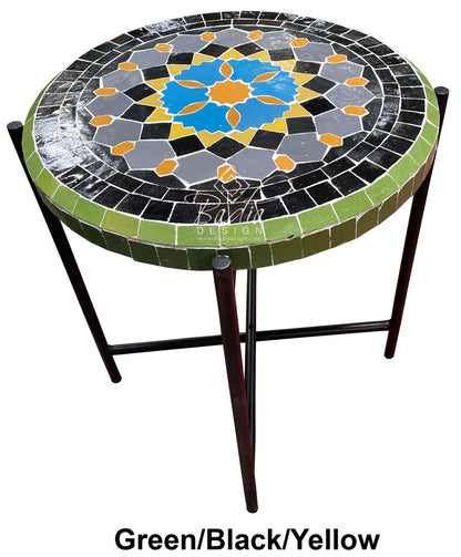 Round mosaic table with green, black, and yellow pattern on a white background