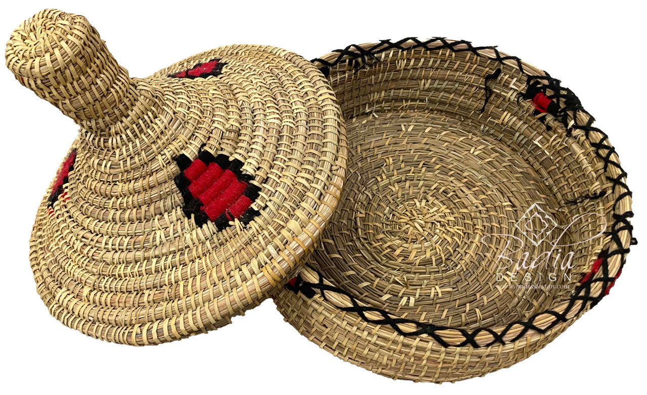 Woven straw lid and basket with decorative red and black patterns on a white background