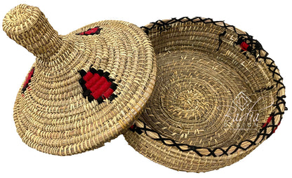 Woven straw lid and basket with decorative red and black patterns on a white background