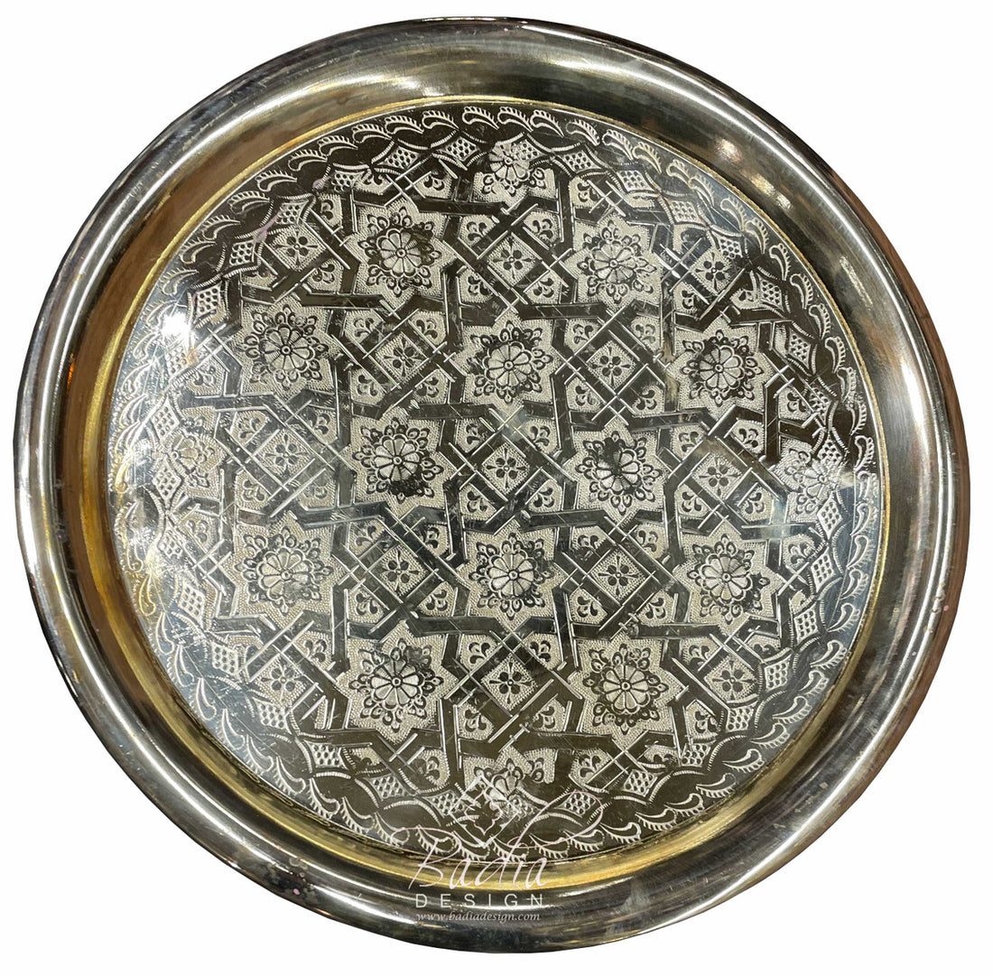 Decorative metal tray with intricate geometric pattern on a white background