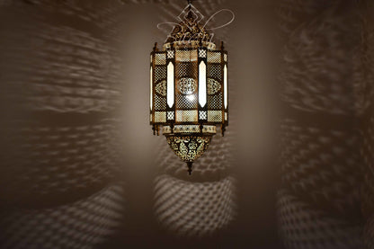 Decorative lantern casting shadows on a wall