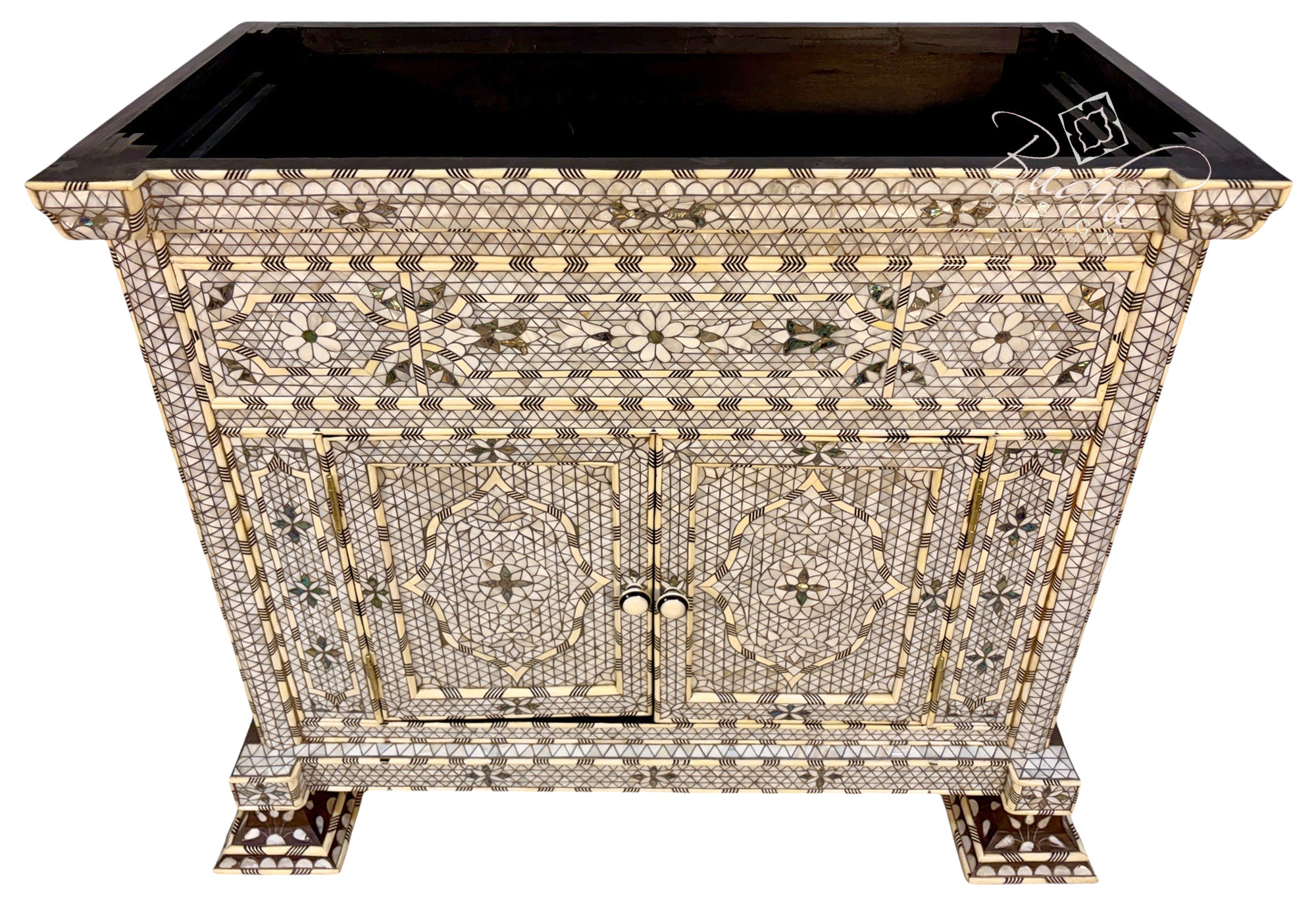 An ornate rectangular cabinet with a black top and legs, covered in intricate mother-of-pearl and gold inlay patterns, shown on a white background.