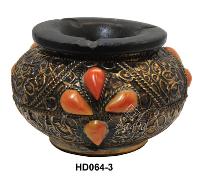 Decorative ceramic pot with black top and orange accents on a white background