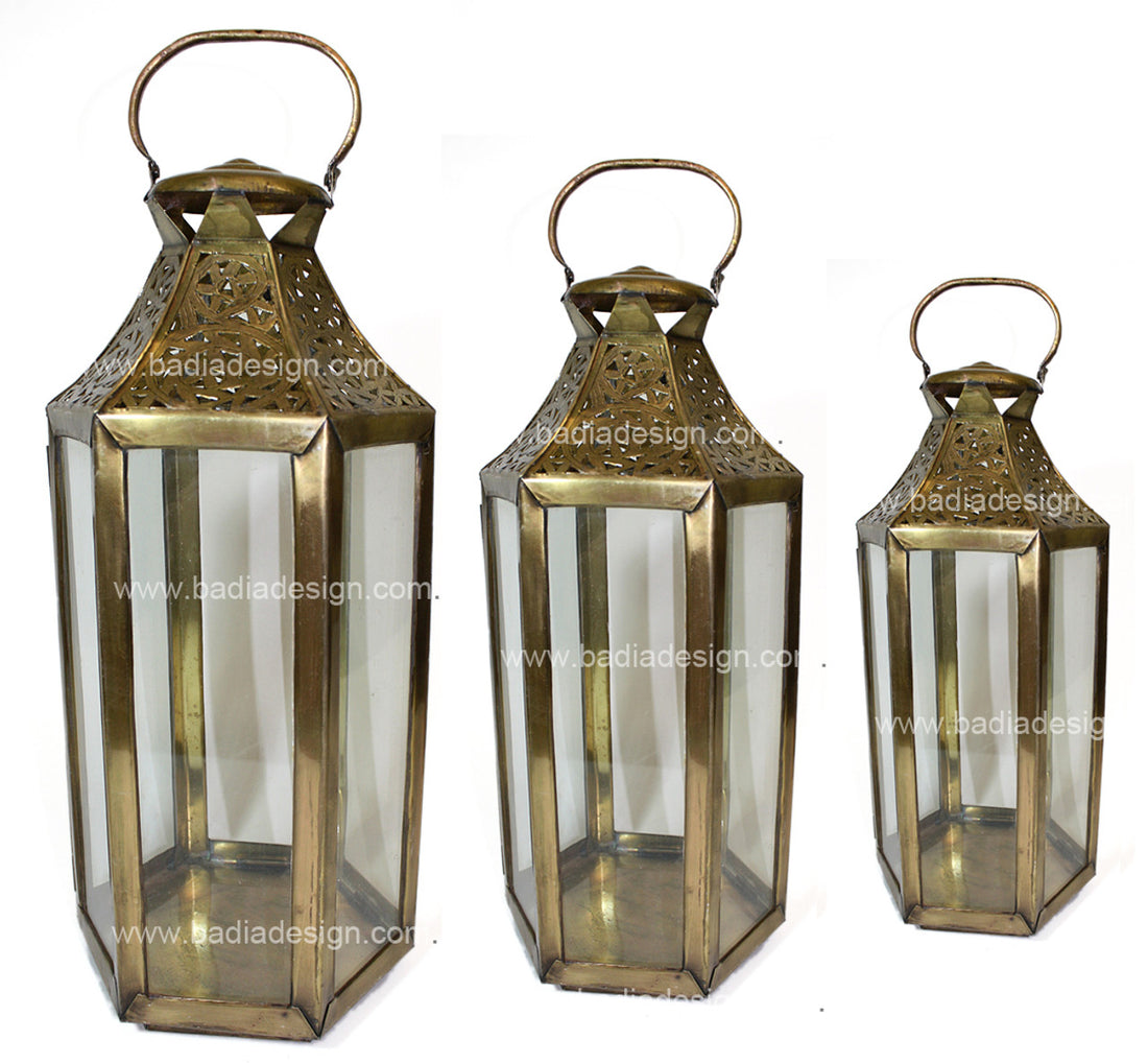 Three brass lanterns of different sizes on a white background with &