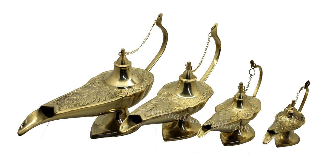Set of four brass genie lamps on a white background
