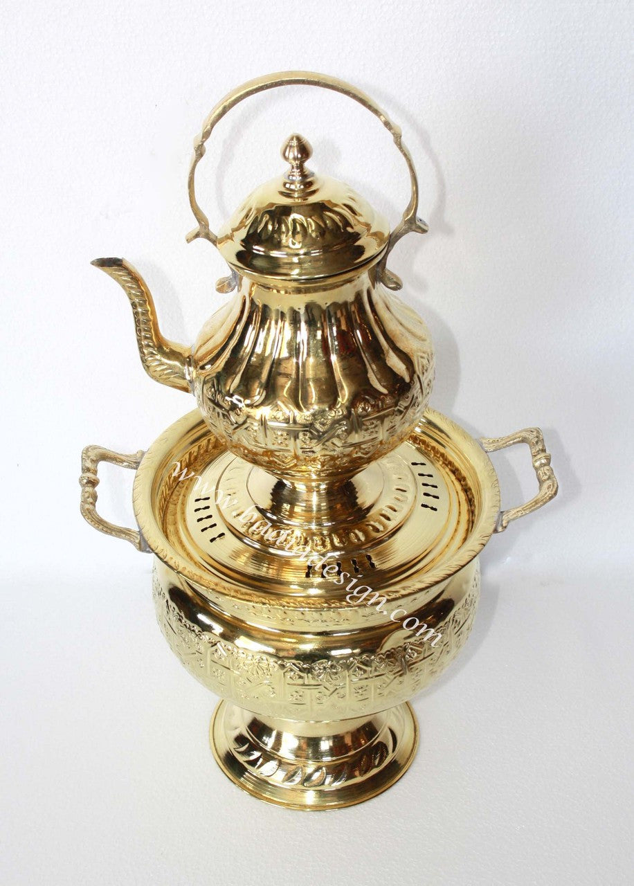 Gold-colored teapot with lid on a white background