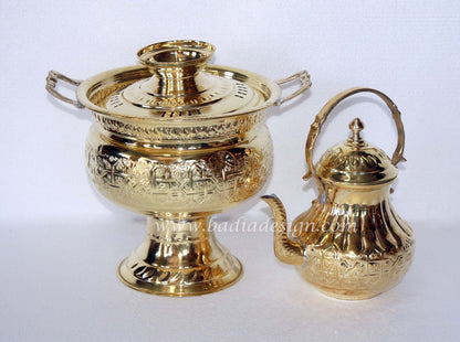 Two gold brass containers with intricate designs on a white background