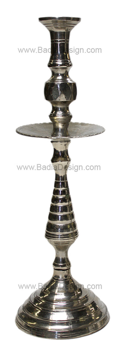 Silver candle holder with intricate design on a white background