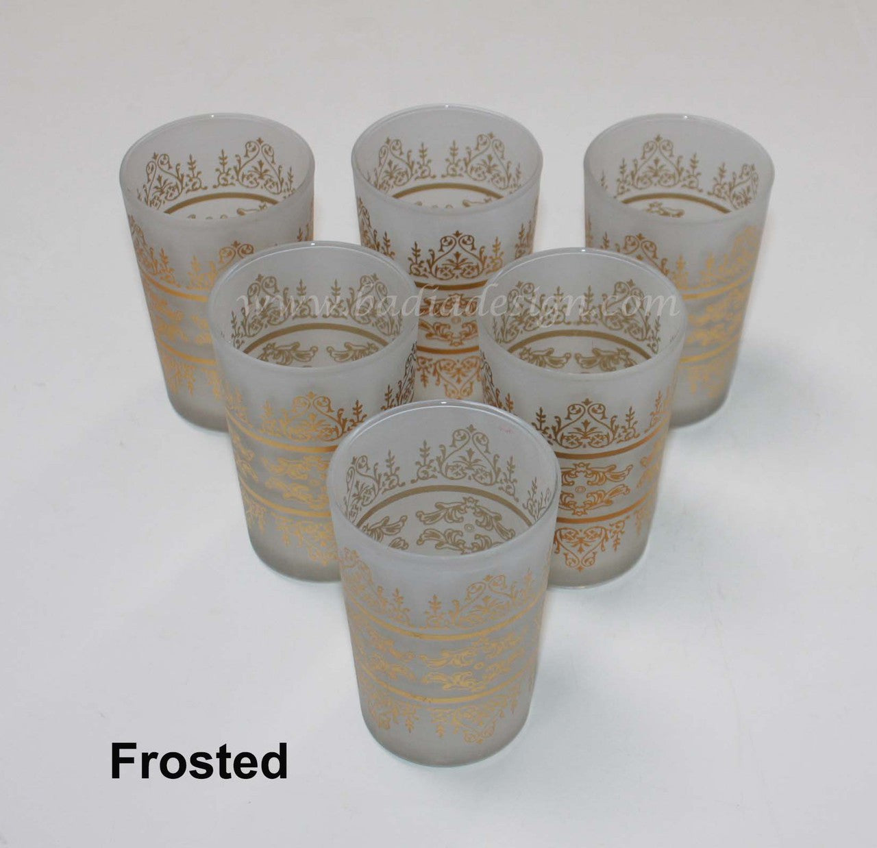 Set of six frosted glasses with gold decorative patterns on a white background