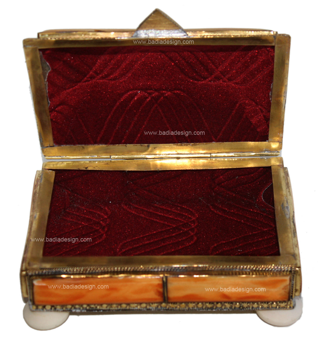 Decorative jewelry box with red interior and gold trim on a white background