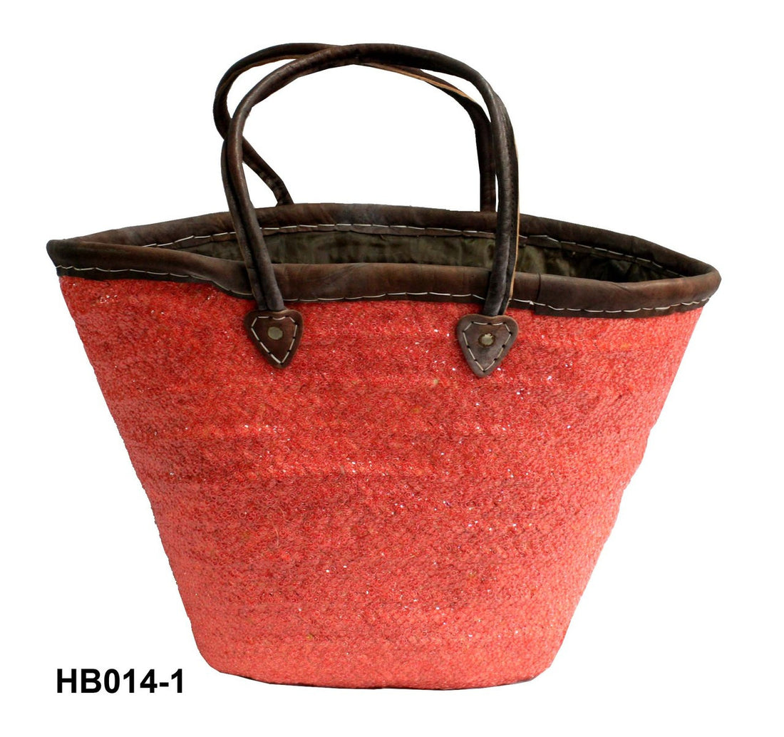 Red woven basket with brown leather handles on a white background