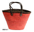 Red woven basket with brown leather handles on a white background