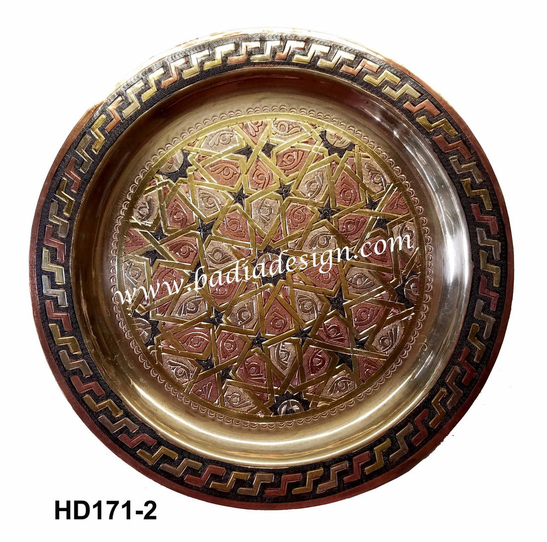 Decorative metal tray with intricate patterns on a white background
