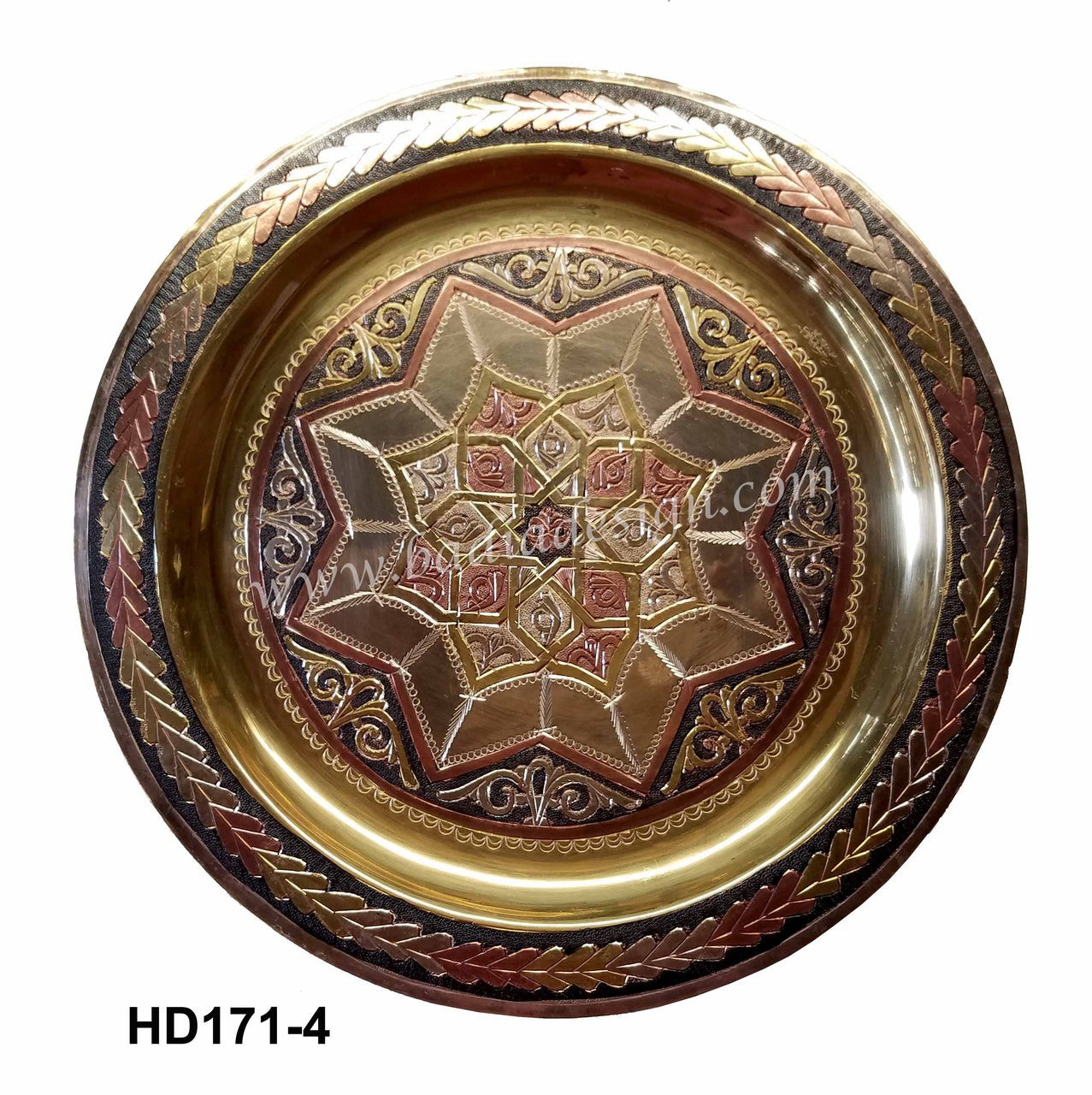 Decorative metal plate with intricate designs on a white background