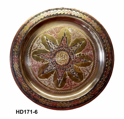 Decorative metal plate with star design and leaf patterns on a white background