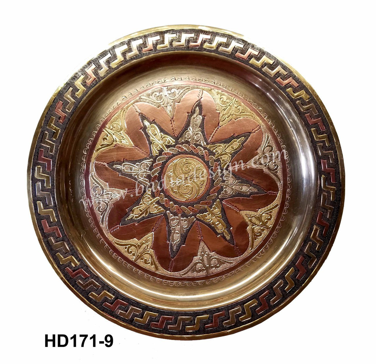 Decorative metal tray with sun design and intricate border on a white background