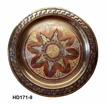 Decorative metal tray with sun design and intricate border on a white background