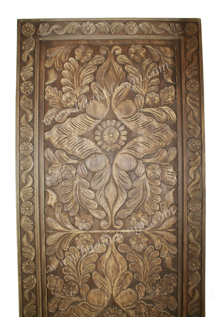 Decorative wooden panel with intricate carvings on a white background