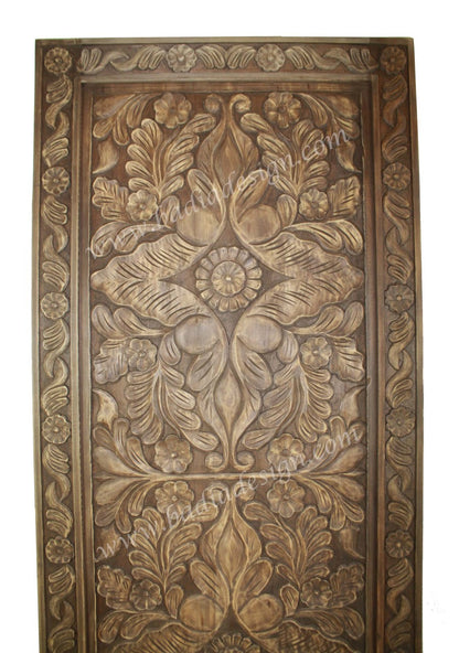 Decorative wooden panel with intricate carvings on a white background