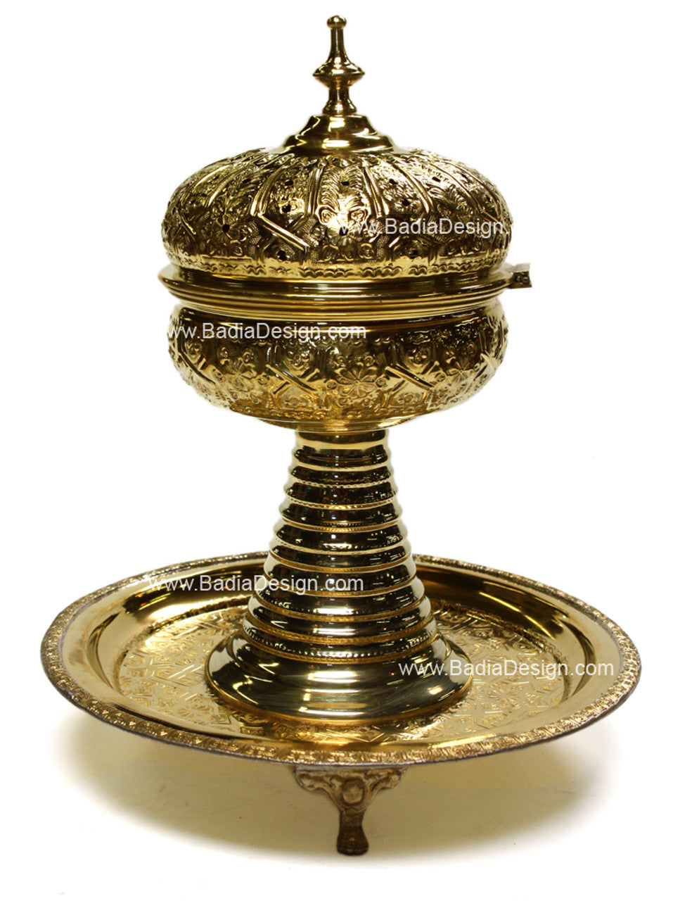 Decorative brass incense burner with intricate designs on a white background